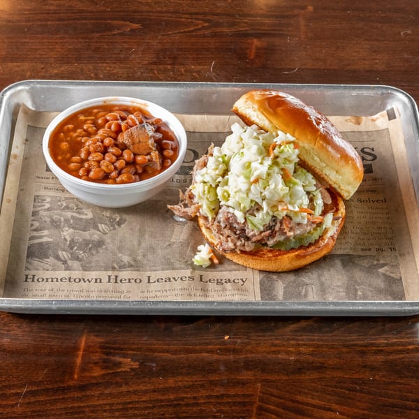 Gaskins Barbecue and Lobster's pulled pork sandwich with coleslaw and a side of baked beans.