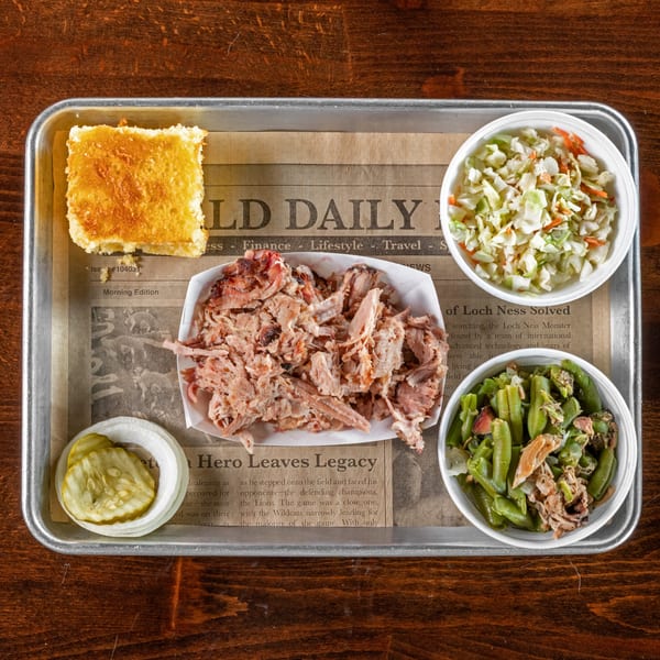 Gaskins Barbecue and Lobster's BBQ tray with pulled pork, coleslaw, green beans, cornbread, and pickles.